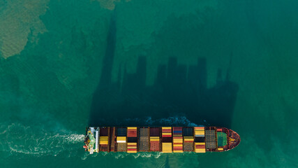 corgo ship container and shadow reflection in sea. is a transport and distribution system to...