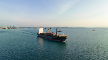corgo ship container in sea and commercail port background. is a transport and distribution system to consumers and dealers marine in the current. aerial view