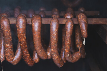 Home roasting of quality sausages made from home-made killer sausages, which are currently being smoked in a wooden shed at a precise temperature
