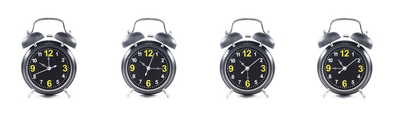 close up of a set of black alarm clocks showing the time; 10, 10.15, 10.30 and 10.45 p.m dan a.m. Isolated on white background
 - obrazy, fototapety, plakaty