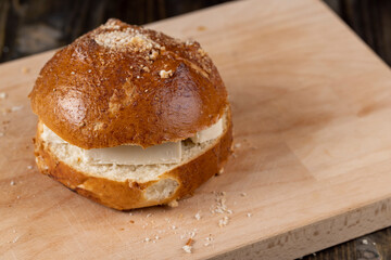 Wheat bun with large pieces of processed cheese inside