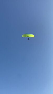 Vertical view of paraglading people flying over a temple facade front in Luxor, Egypt