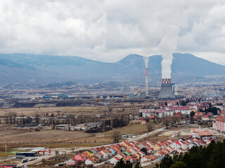 Thermal power station expelling pollutants to the air. City with poor air quality due to thermal...