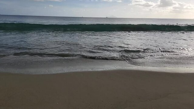 SloMo-Waves Break On Pristine Sandy Beach - Low Angle