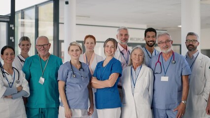 Happy doctors, nurses and other medical staff posing in hospital. - Powered by Adobe