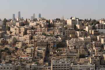 View onto an older part of Amman with skyscrapers in the background, contrast between old and modern Amman, Jordan