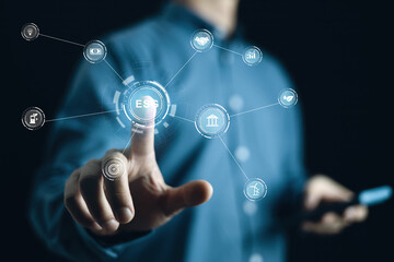 Fototapeta premium ESG concept. Business man touching ESG icon in the hand for environmental, social, and governance in sustainable and ethical business on the Network connection on a green background.