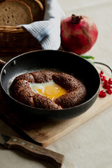 Turkish breakfast, scrambled eggs in a simit bun in a frying pan, coffee in a Turk, fresh bread