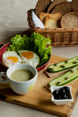 classic breakfast, scrambled eggs, simit bun, fresh vegetables, cucumber