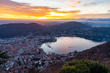 The city of Como, the lakefront and the lake, photographed from Brunate, at dusk, and all the...