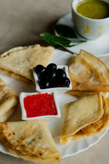Pancake with red caviar and olives for breakfast, mint coffee