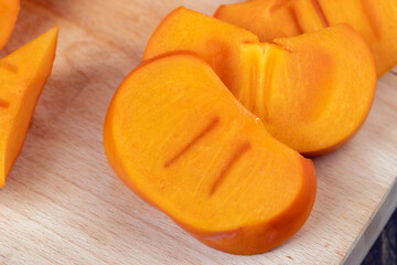 Sliced ripe orange pitted persimmon