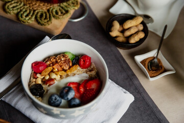 breakfast set, oatmeal with berries and yogurt, black tea with roses, bread