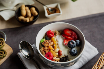 breakfast set oatmeal with berries and black tea with rose flowers