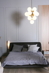 bedroom corner interior with bed, pillows, night stand and book case close up photo