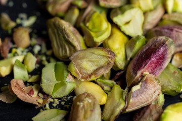 Scattered pistachios of green color with salty taste