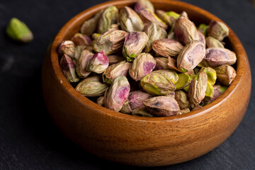 Crispy delicious pistachios with salt on the table