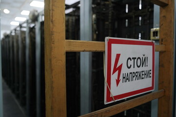 Almaty, Kazakhstan - 10.07.2022 : Russian signboard with the inscription: Stop, tension. Power...