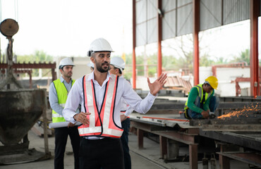 Group of architects, construction foremen, and construction engineers review the work and talk about how the project, in the construction site.