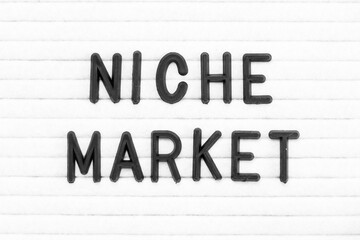 Black color letter in word niche market on white felt board background