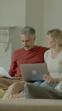 Couple at Home Looking at Personal Finances using a Laptop