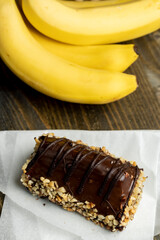 Fresh sweet cake with banana in chocolate glaze and milk filling