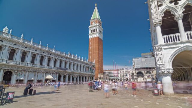 Campanile di San Marco (St Mark's belfry) and Palazzo Ducale (Doge's Palace), from waterfront timelapse hyperlapse, Venice, Italy. Columns of San Marco and San Todaro. Blue cloudy sky at summer day