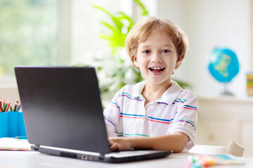 Online remote learning. School kids with computer.