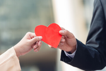 Banner of businesswoman and boss show red heart in hands for romantic date at valentine. Two lover holding red present paper symbol for show love. Couple partner friend happy in valentine day.