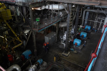 Almaty, Kazakhstan - 10.07.2022 : Pipes, valves and pressure sensors in the generator room at the heating plant.