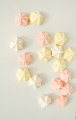 Pink, yellow and white merengue candy in a white background 