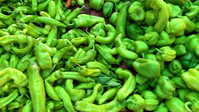 Top view footage of green and red peppers at farmer's market captured in Ayvalik, Turkey. Camera moves around