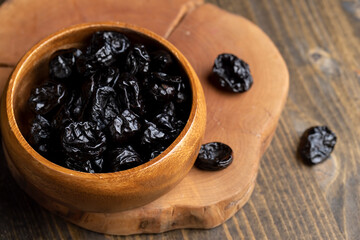 Black pile of prunes from a large number of ripe plums