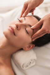 Woman during face massage in salon