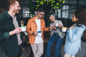 Relaxed office workers enjoying drinks during break
