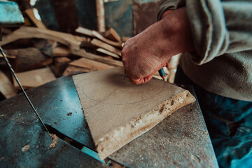 Closeup photo of a senior man outlining wood and preparing it for processing