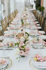 Wedding decorations. Served wedding table with decorative fresh pink flowers and candles....