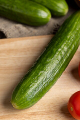 Sliced green long cucumber during salad preparation