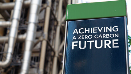 Achieving a zero carbon future on a sign in front of an Industrial building	
