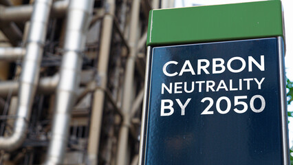 Carbon Neutrality by 2050 on a sign in front of an Industrial building	