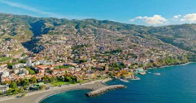 Aerial top view cityscape town on the coast and mountains around of Funchal the largest city the municipal seat and the capital of Portugal's autonomous region of Madeira island in the Atlantic Ocean.