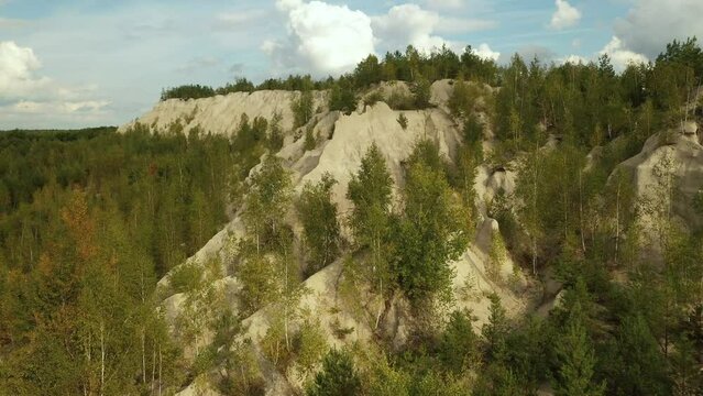 A very beautiful lake among the hills, quartz mountains and the endless Ukrainian forest. Bright, sunny day. Druzhbovsky quarry, Zhytomyr region, Ukraine.
