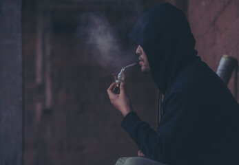 Close up portrait of brutal man in the smoke holding a cigar