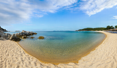 Summer sea coast landscape (Tristinika beach, Halkidiki, Sithonia, Greece). People are unrecognizable. High-resolution panorama.