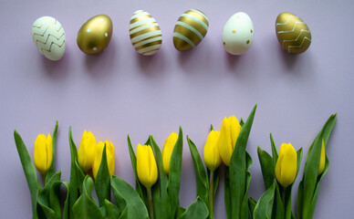 Easter eggs of gold, white color with a pattern and yellow tulips on a purple background. Copy space