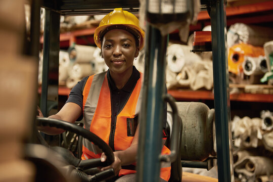 African female forklift operator working in a warehouse
