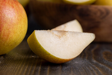A yellow ripe pear with a red side on the table