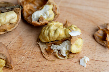 Open and broken walnut shells lying on the table