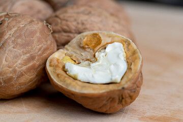 Open and broken walnut shells lying on the table
