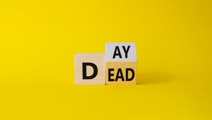 Day of the Dead symbol. Turned wooden cubes with words Day of the Dead. Beautiful yellow background. Day of the Dead concept. Copy space.